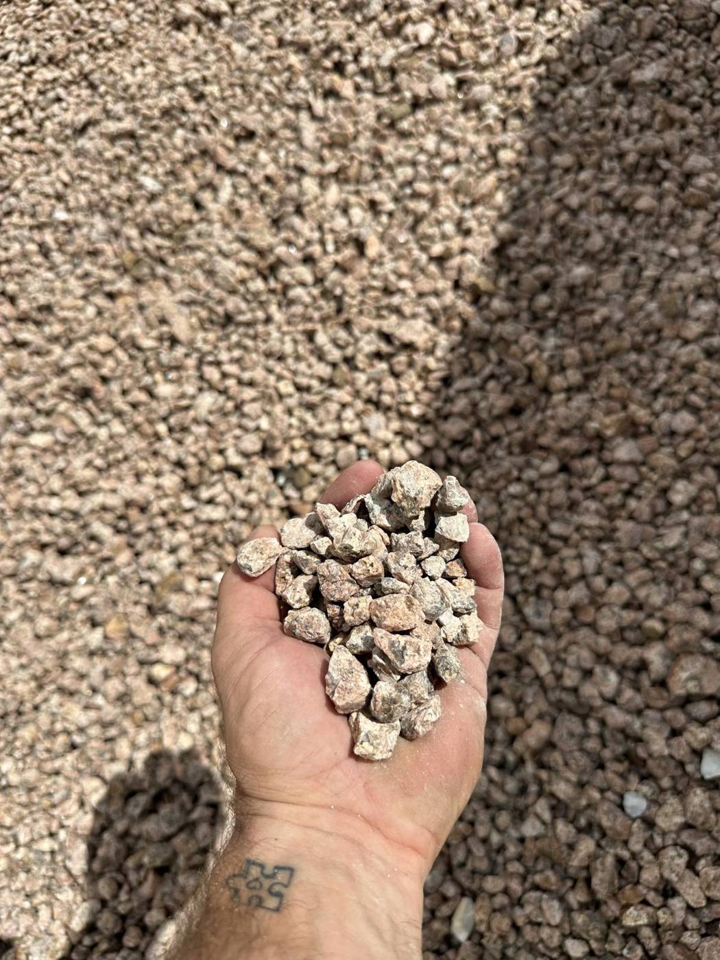 Handful of decorative crushed gravel for landscape beds and paths