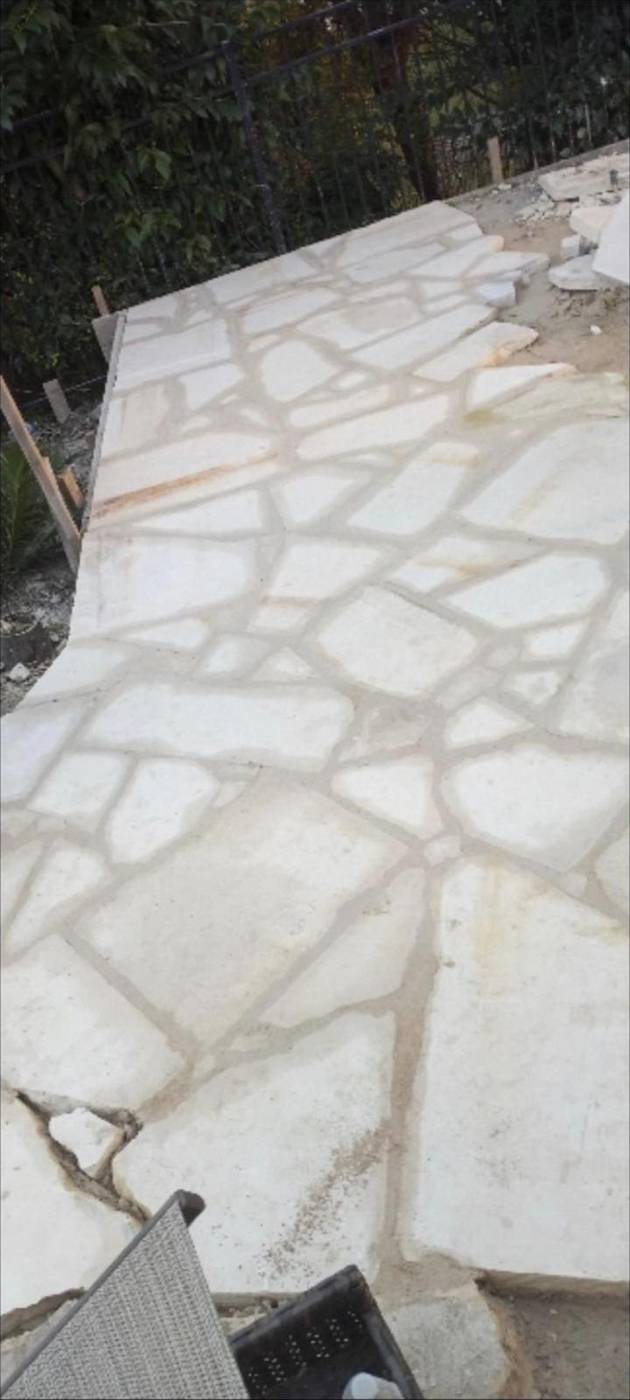 Irregular white limestone flagstone patio with tight mortar joints