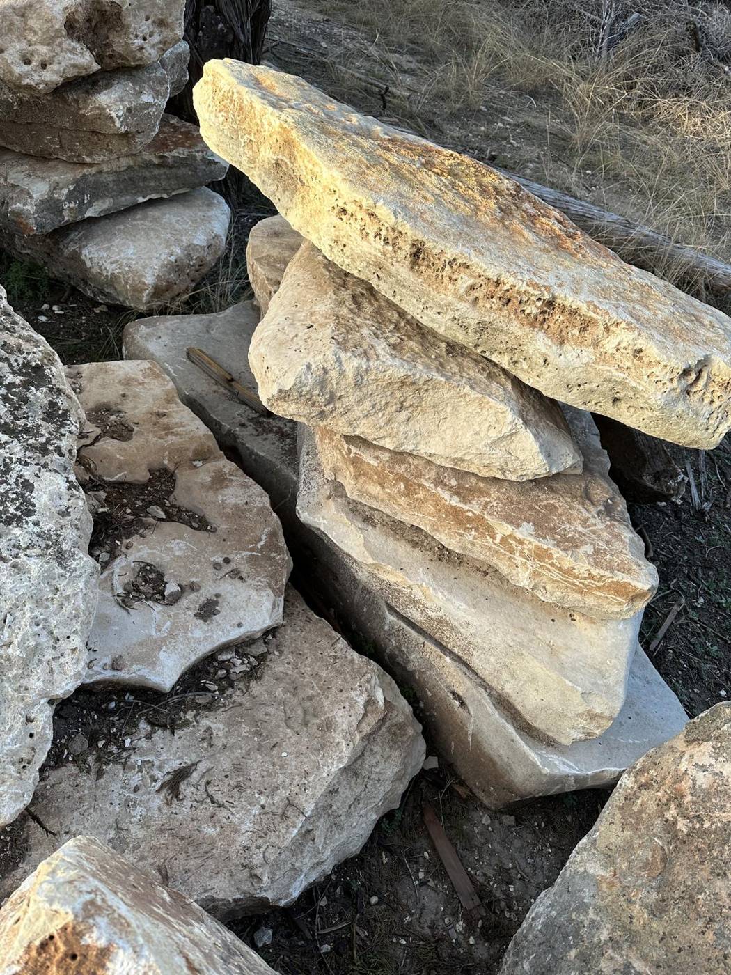 Large limestone flagstone slabs stacked for a project